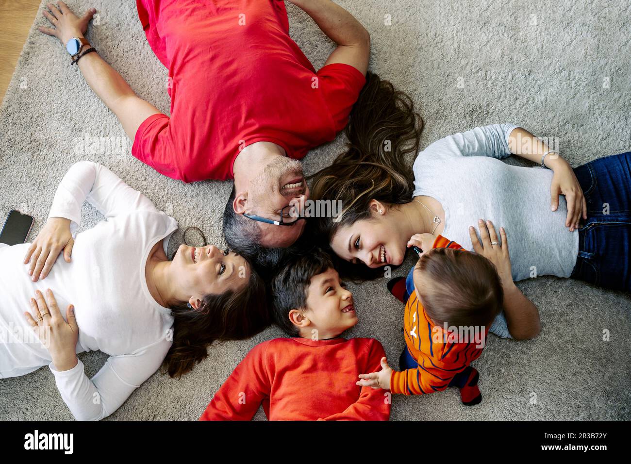 Happy family lying down hi-res stock photography and images - Alamy