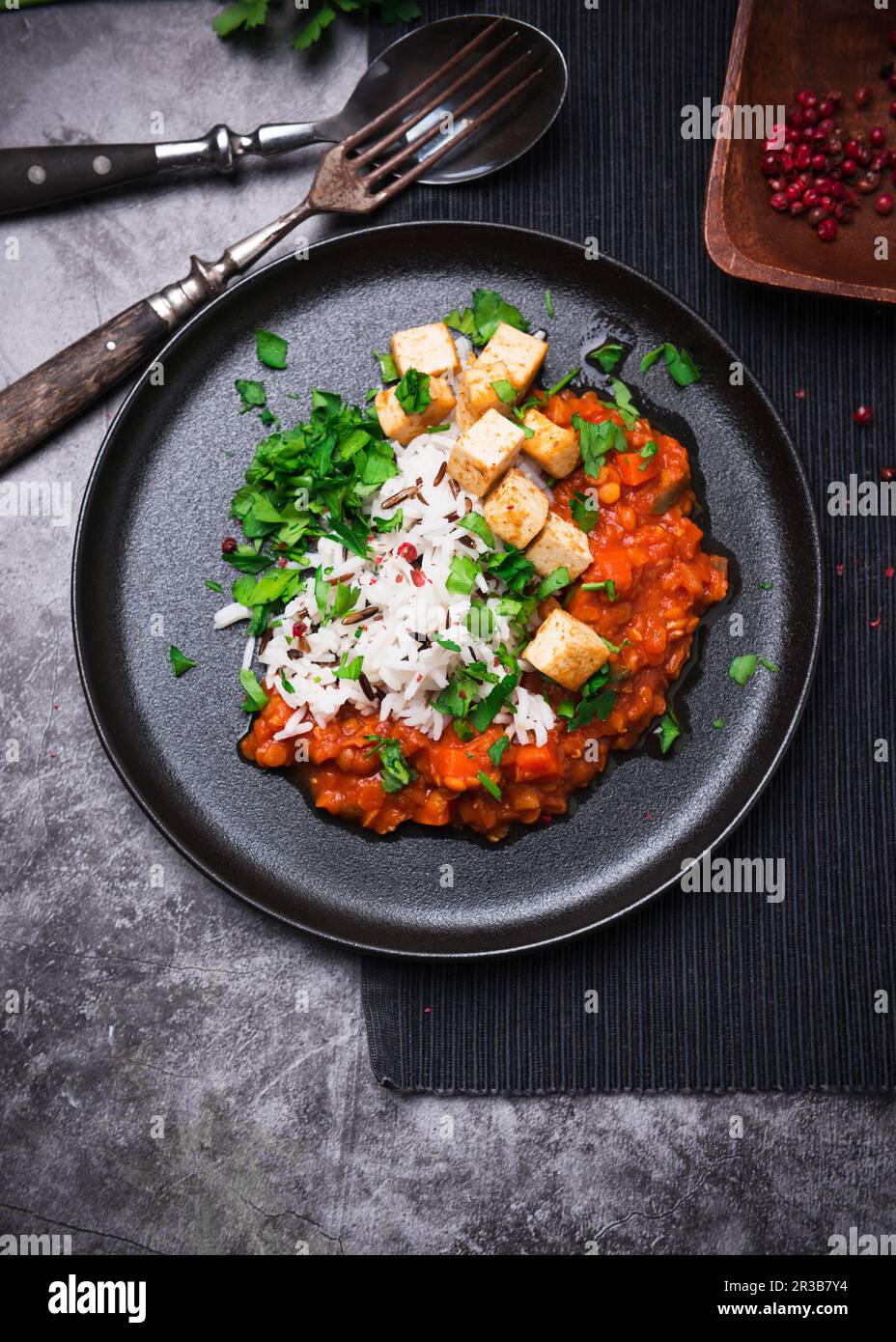 Vegan lentil and carrot bolognese with fried tofu and wild rice and basmati mixture Stock Photo