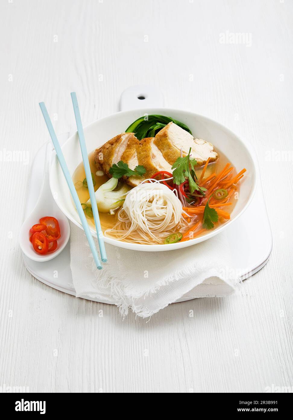 Chicken noodle soup with white thin noodles, Pak Choi, carrot, green
