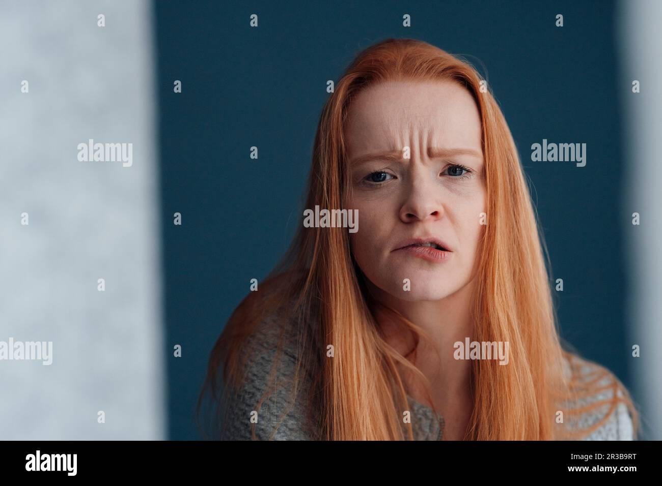 Redhead woman making facial expression Stock Photo