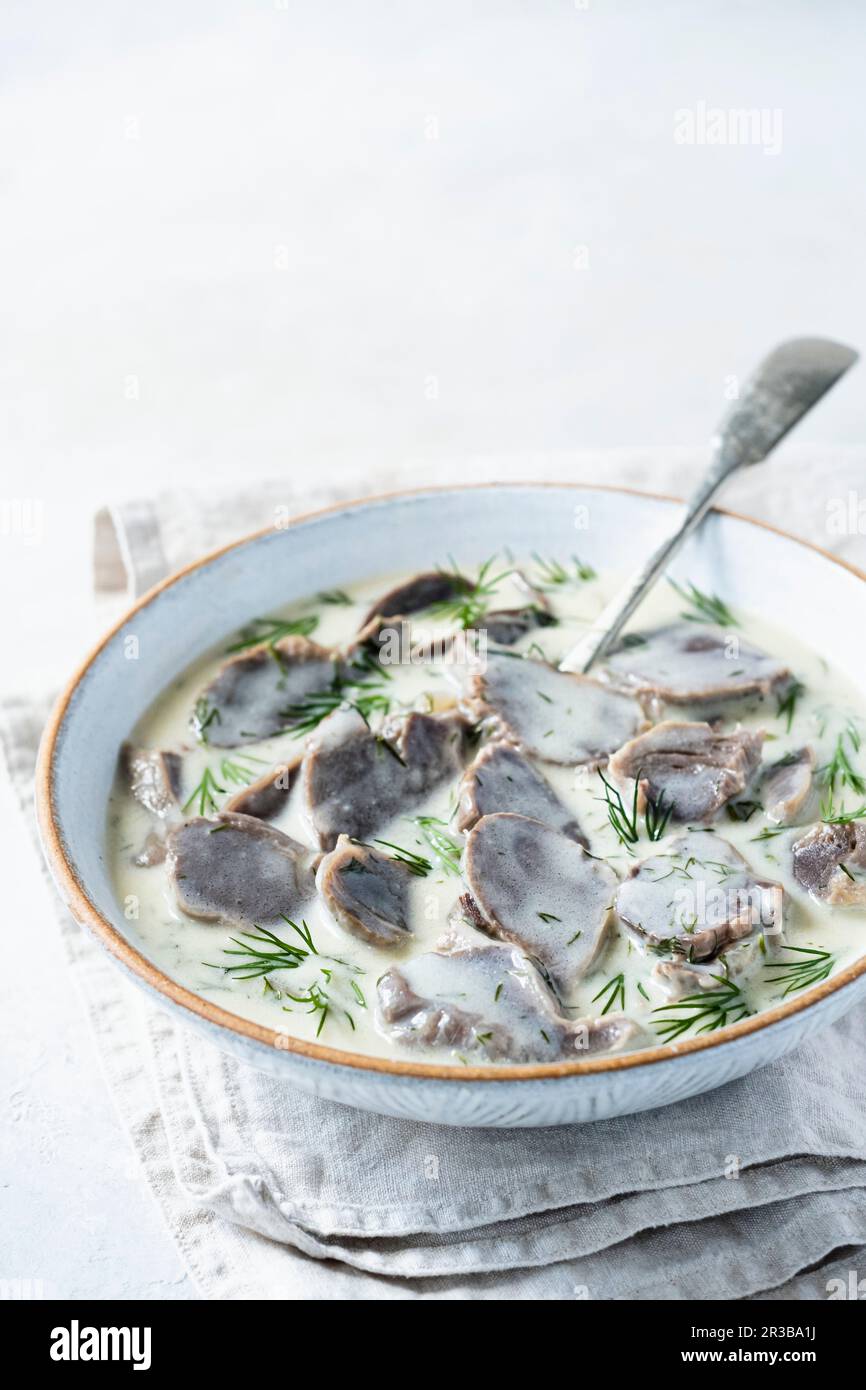 Turkey stomachs in dill sauce Stock Photo - Alamy