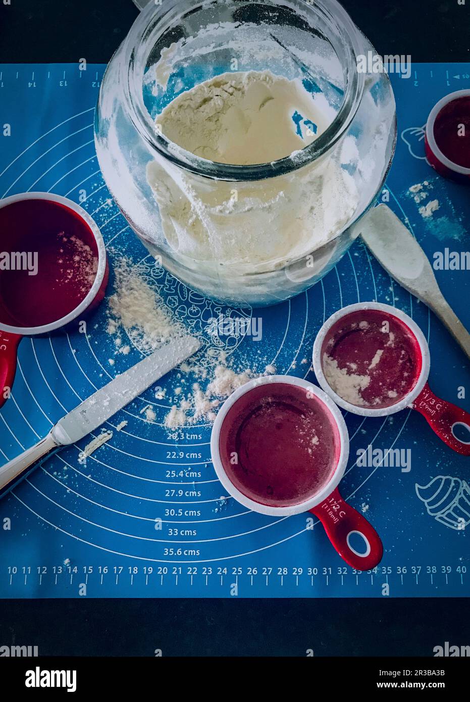 An arrangement of baking ingredients with flour and ramekins Stock
