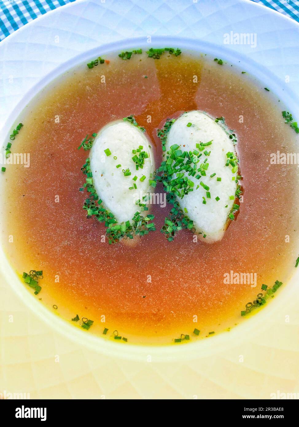 Semolina dumpling soup with chives Stock Photo