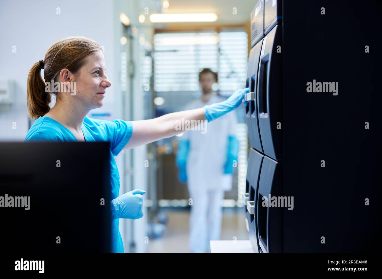 Smiling scientist working in microbiological laboratory Stock Photo