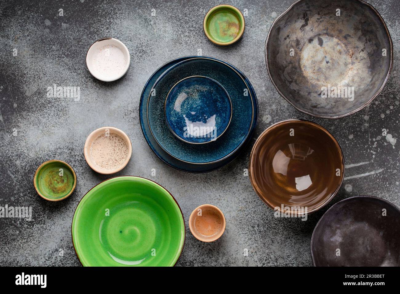 Assorted ceramic hand-made multicolored empty plates and bowls Stock Photo