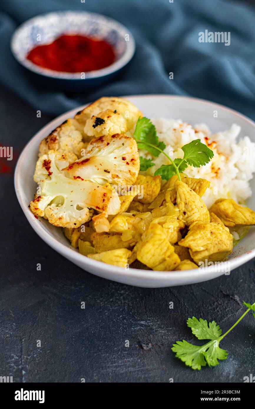 Coconut curry chicken with roasted cauliflower and rice Stock Photo - Alamy