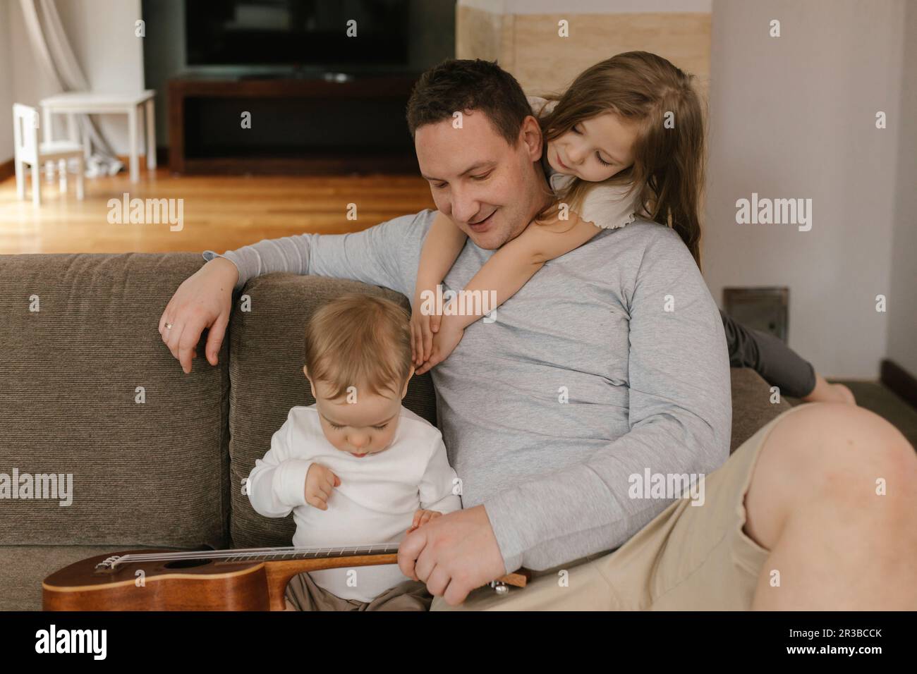 Father spending leisure time with son and daughter at home Stock Photo