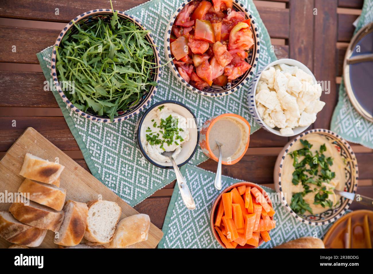 Various healthy meal in bowls with vegan products on table Stock Photo