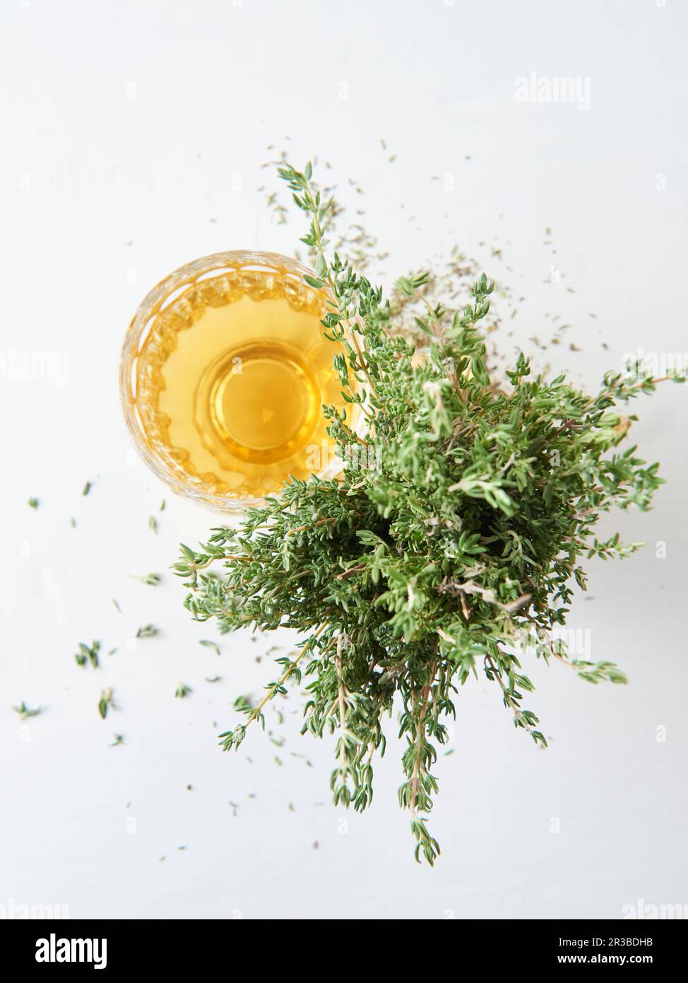 Thyme tea in a glass next to fresh thyme Stock Photo