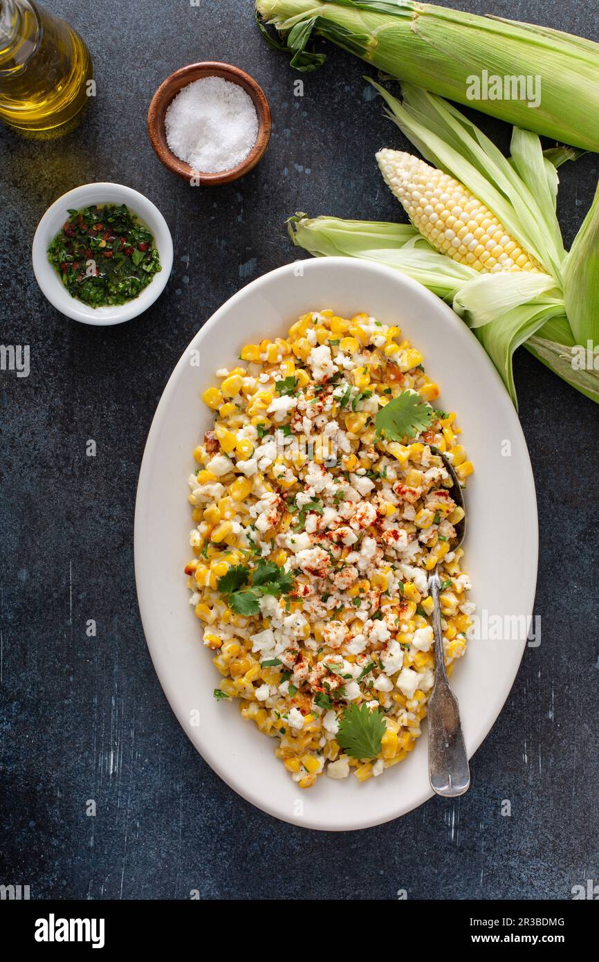 Mexican street corn, elote with cotija cheese, fresh cilantro and chili Stock Photo Alamy