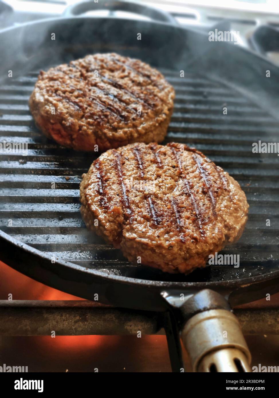 Burger patties in a grill pan Stock Photo Alamy
