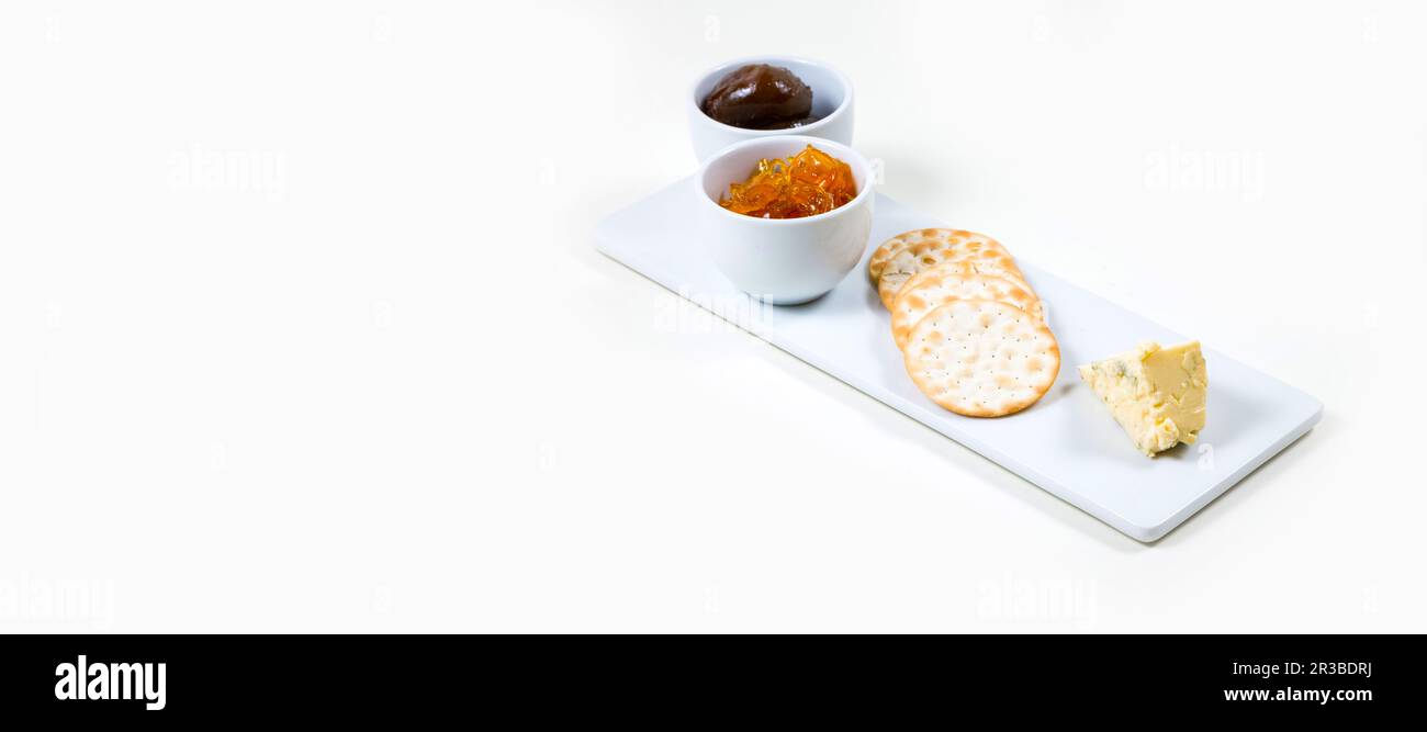 Cheese and Crackers on a white plate on a white background isolated Stock Photo
