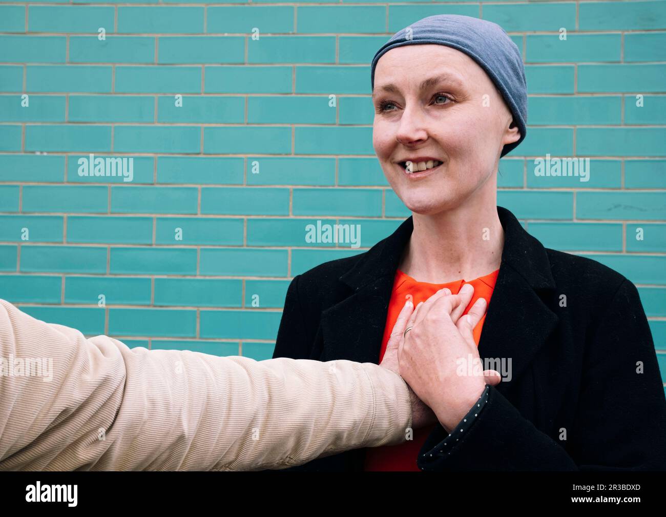 Smiling cancer patient with man's hand on chest Stock Photo Alamy