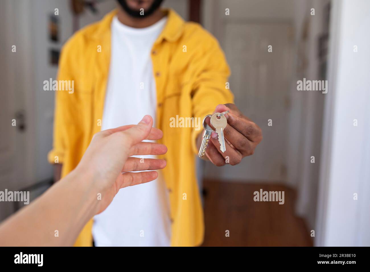 Real estate agent giving house keys to man in new apartment Stock Photo ...