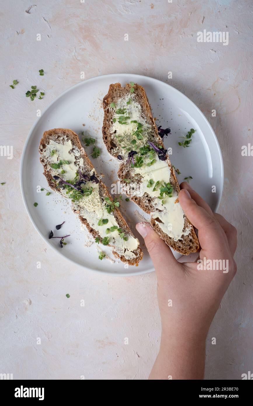 Two slices of sourdough bread with butter and cress Stock Photo
