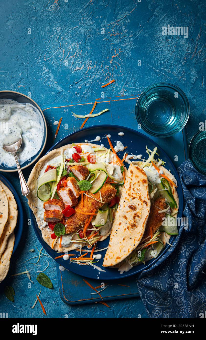Wraps with panko coated chicken, minted yoghurt, tomato salsa, cucumber