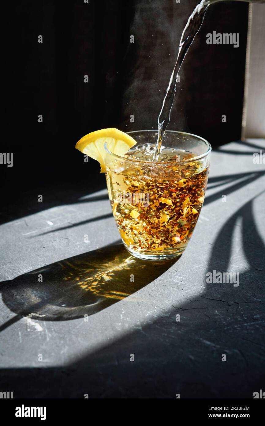 Boiling water being poured over fruit tea Stock Photo Alamy