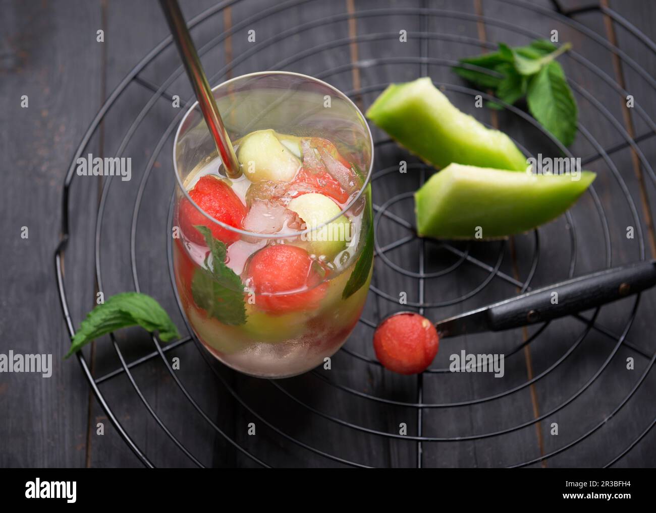 Fizzy white wine Sangria with watermelon and melon balls Stock Photo