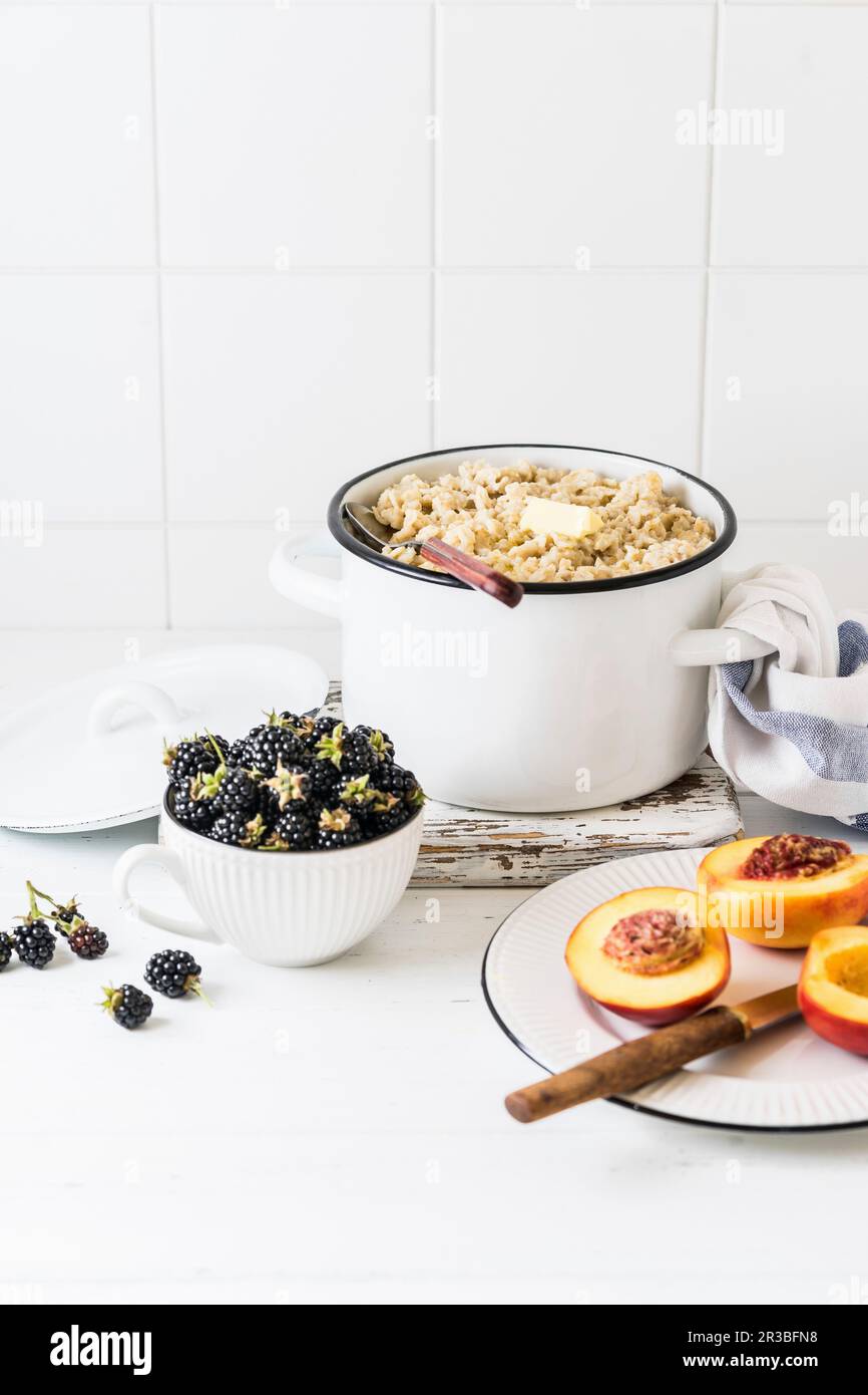 Oat porridge with butter and fresh blackberries Stock Photo