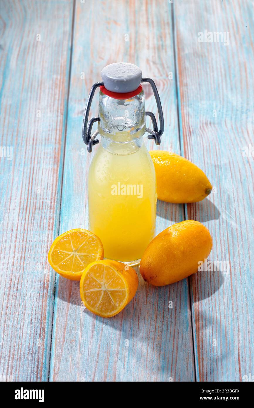 Limequat juice in a swing top bottle Stock Photo Alamy