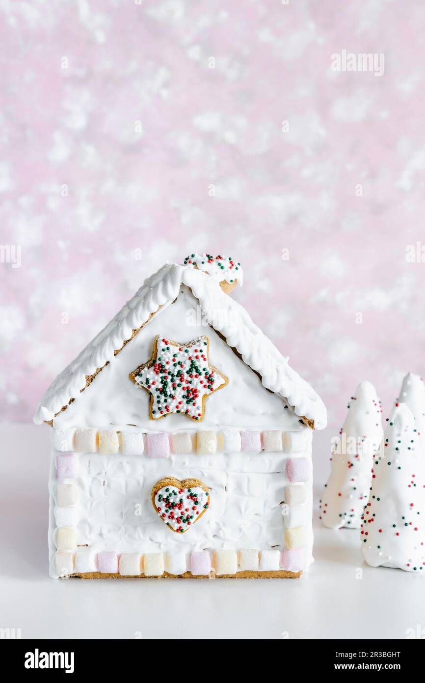 Christmas gingerbread house decorated with marshmallows and royal icing