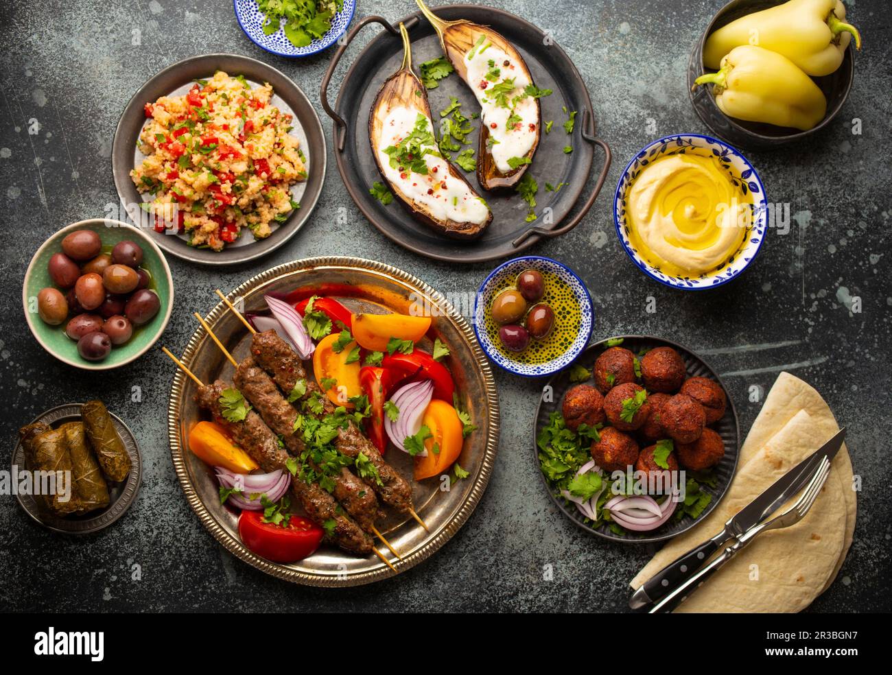 Middle eastern dinner with grilled kebab, falafel, roasted and fresh vegetables Stock Photo