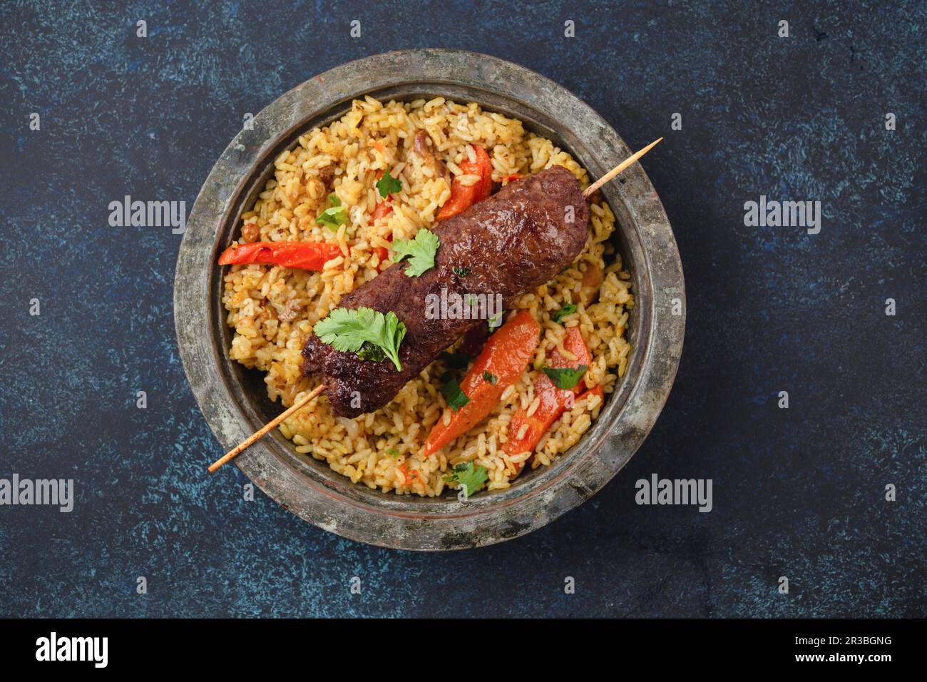 Traditional Middle Eastern meat Kebab with rice in rustic metal plate Stock Photo