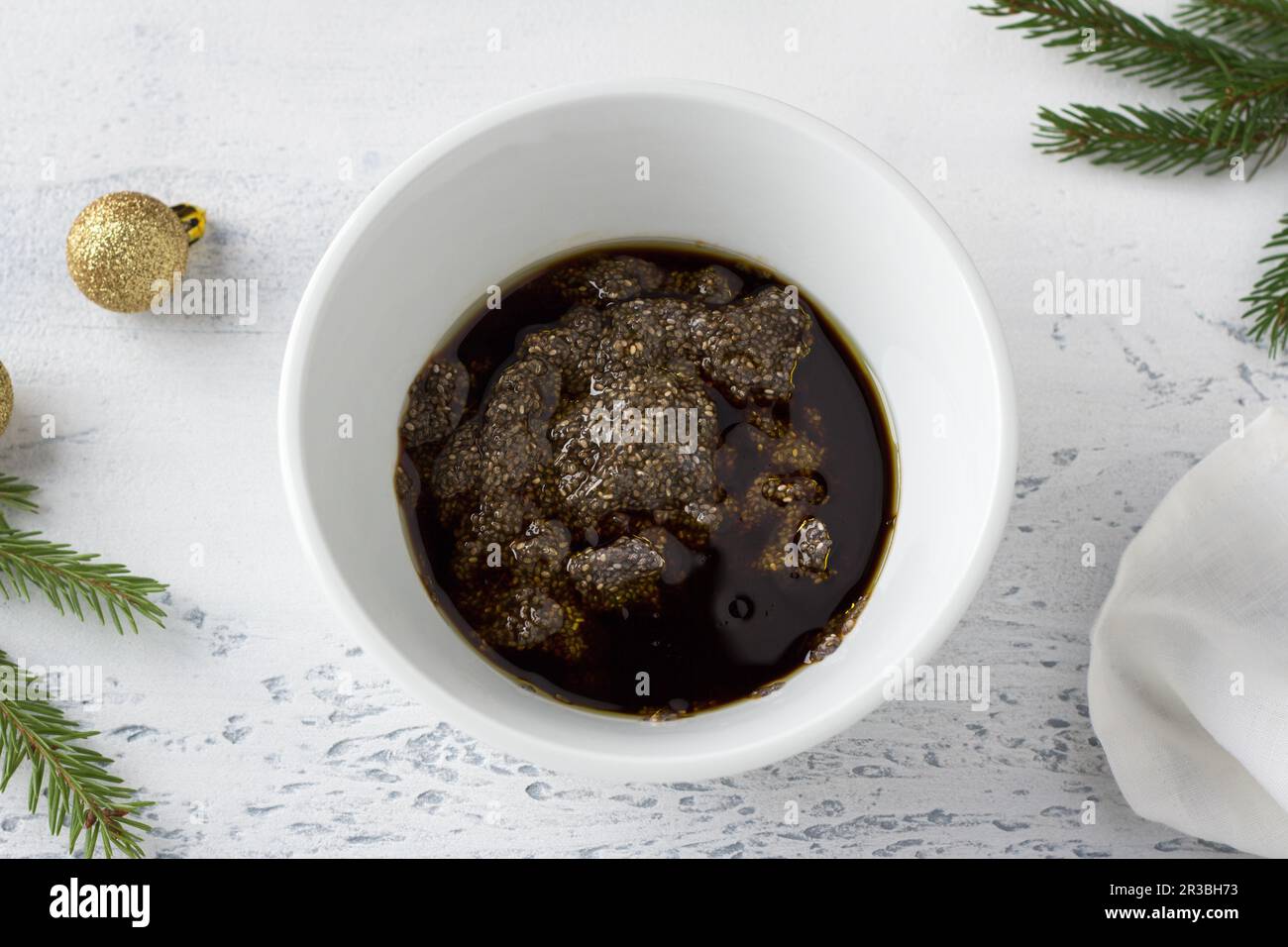 White ceramic bowl with soaked chia seeds drenched in soy sauce and