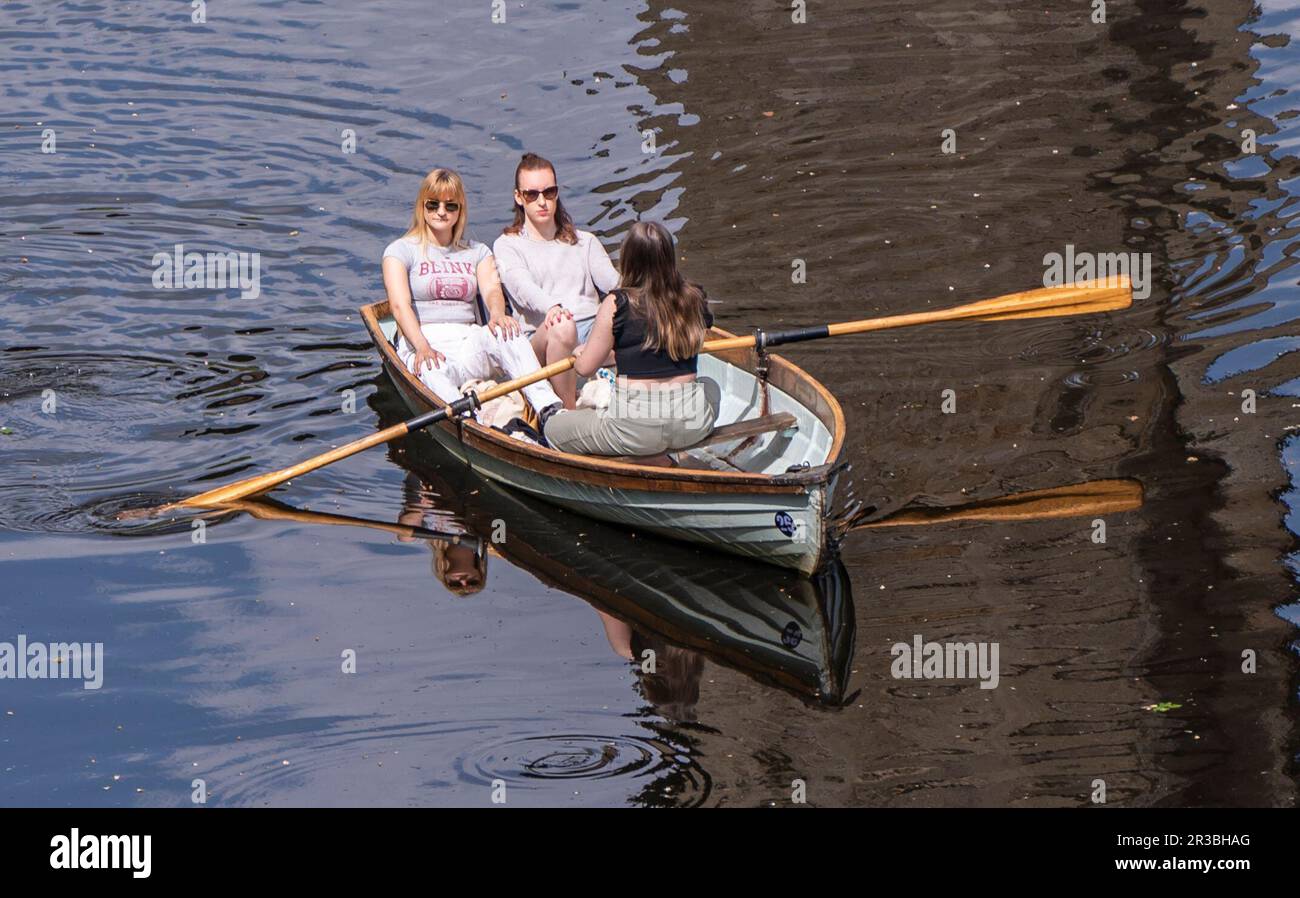 People enjoy the hot weather in a rowing boat on River Nidd in
