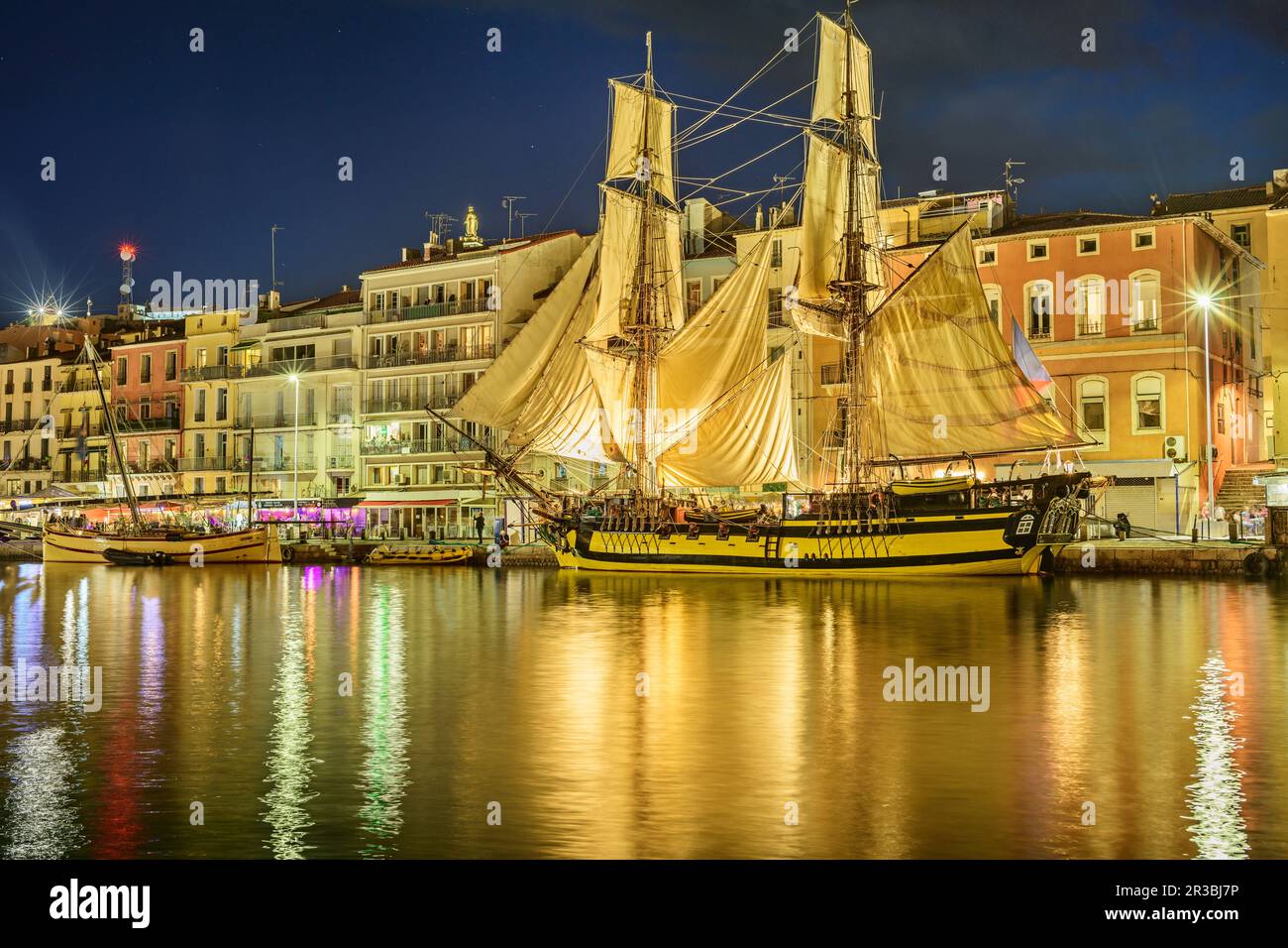 France, Herault, Sete, Sailing ship moored along Canal du Midi at dusk Stock Photo
