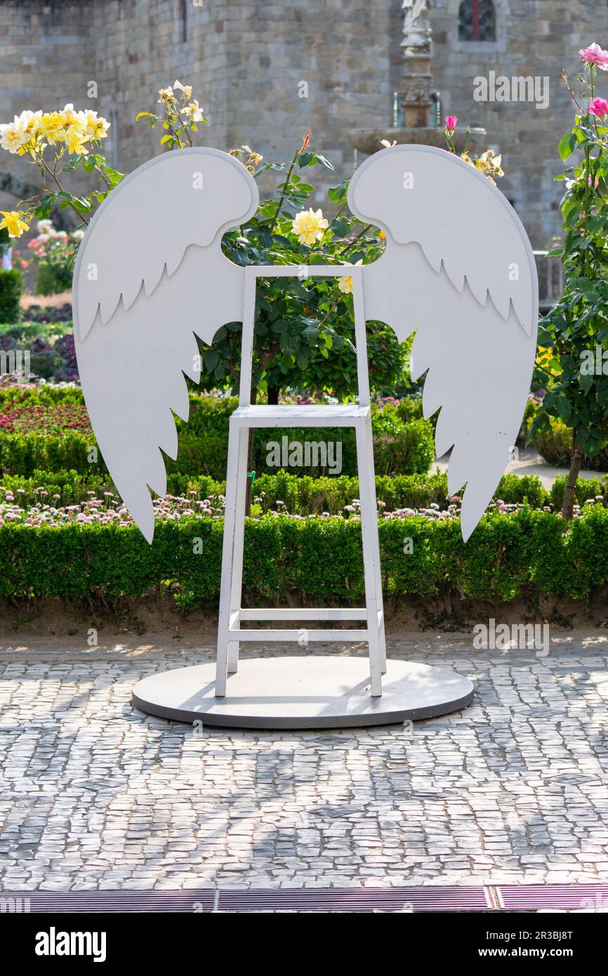 White angel wings chair to sit and take pictures for social media. Braga Romana, jardim de Santa Bárbara. Stock Photo
