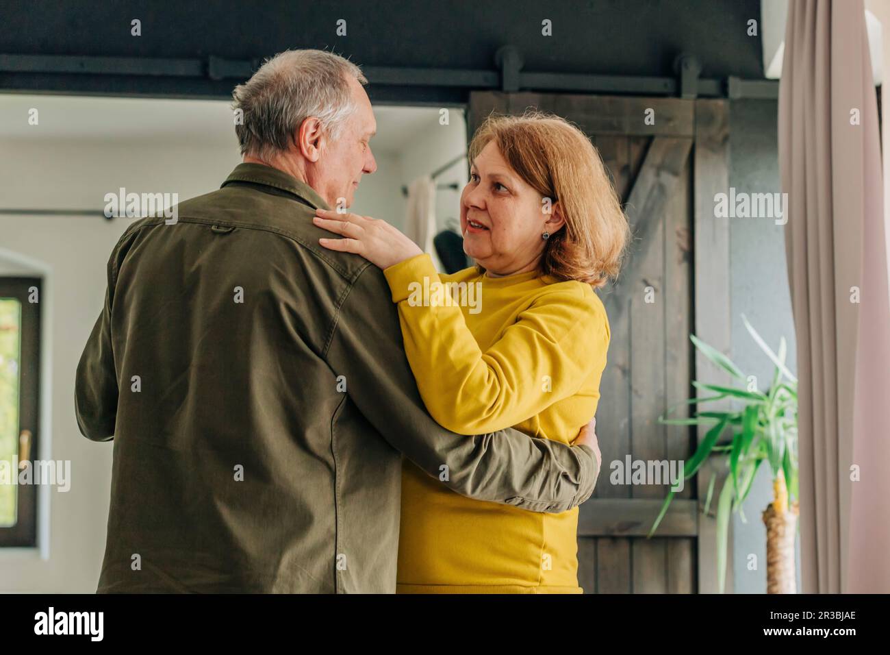Senior couple dancing together at home Stock Photo