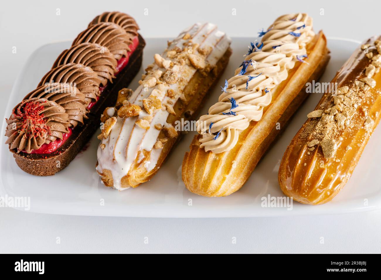 Chocolate, salted caramel, vanilla and earl grey eclairs Stock Photo