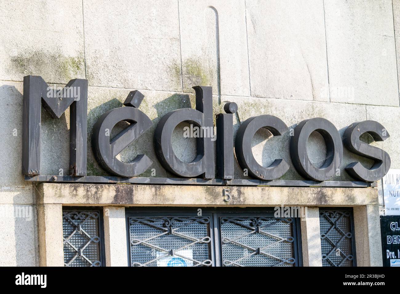 Old medic sign made in metal on a Portuguese building. Vintage sign and business advertising. Stock Photo