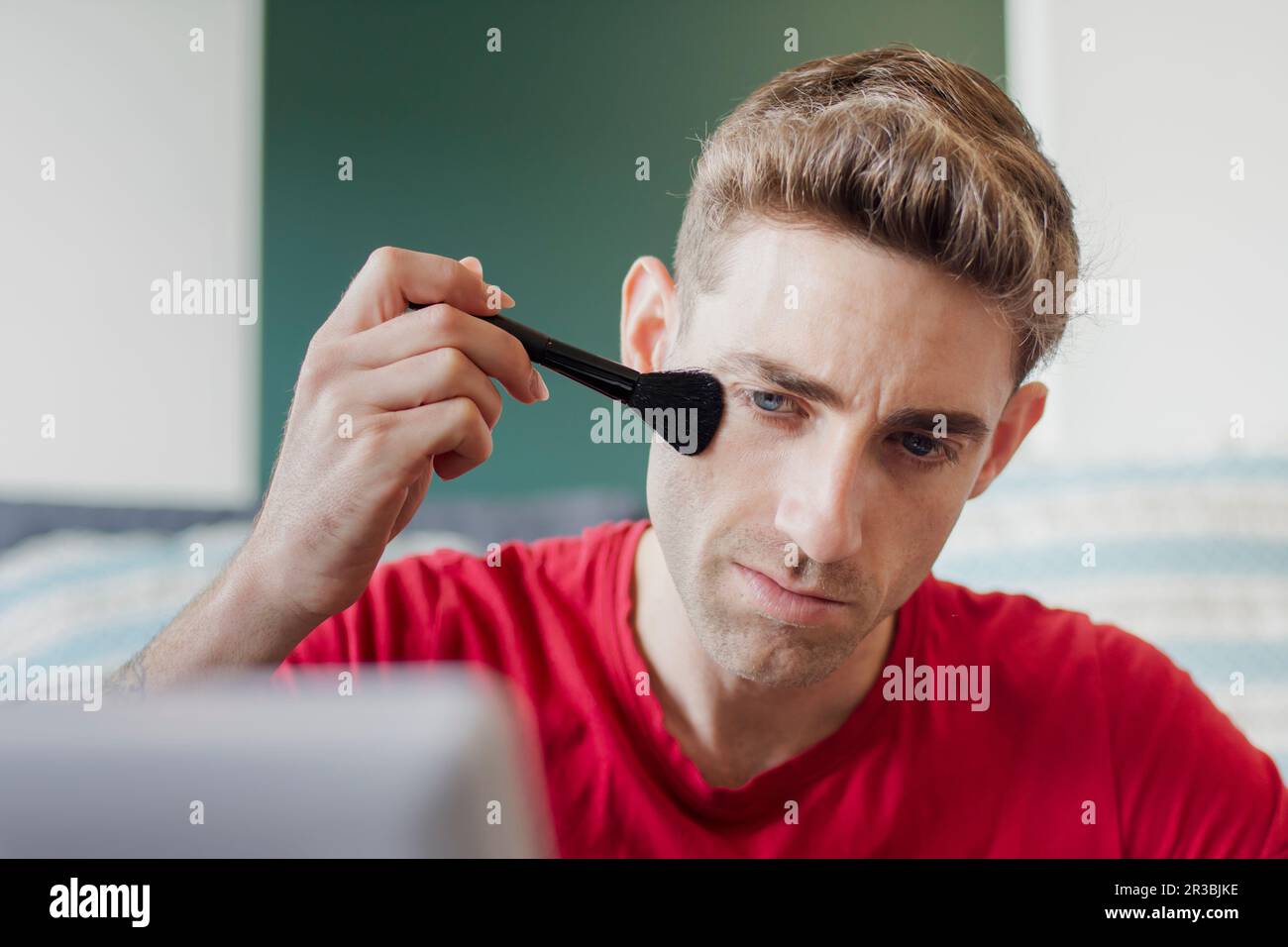 Man applying make-up with brush Stock Photo