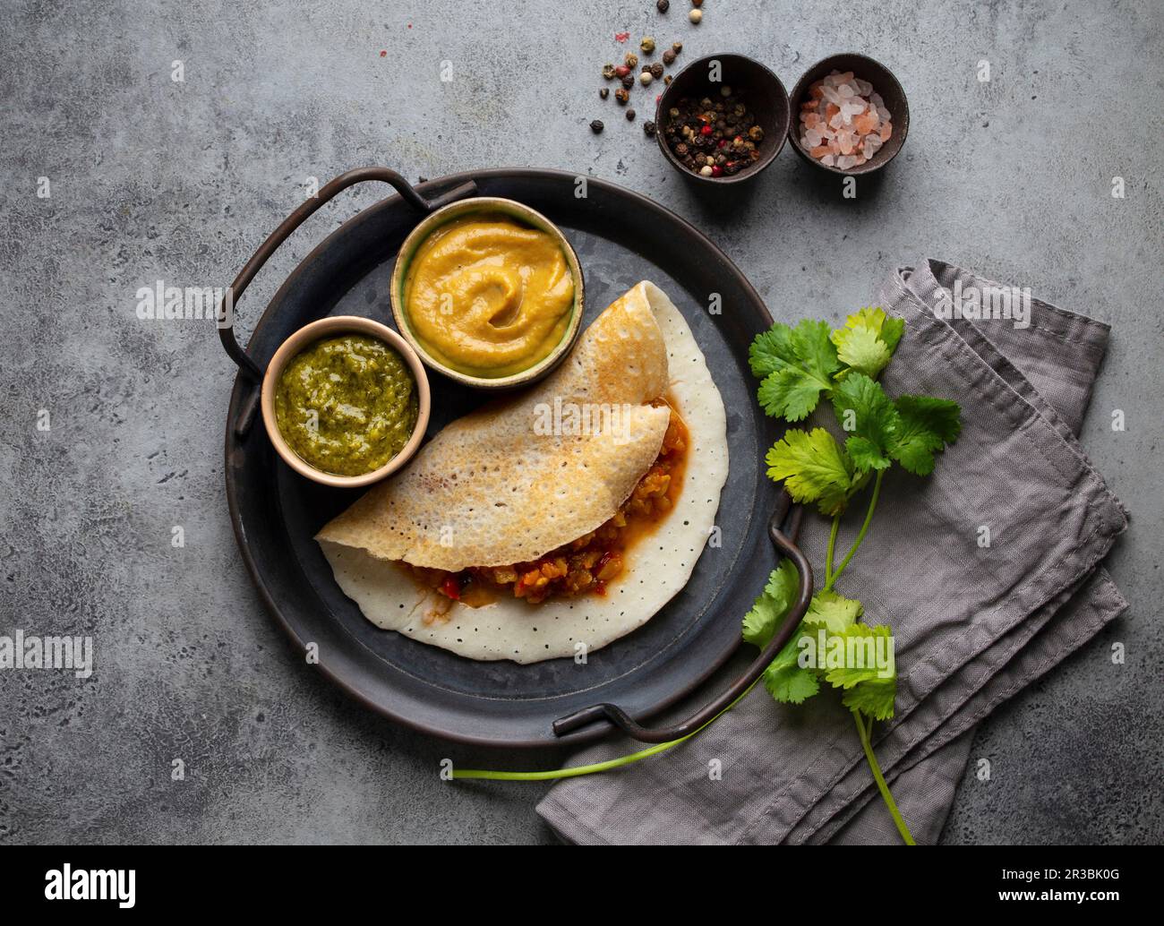 Traditional Indian rice pancakes Dosa with different dips chutney and