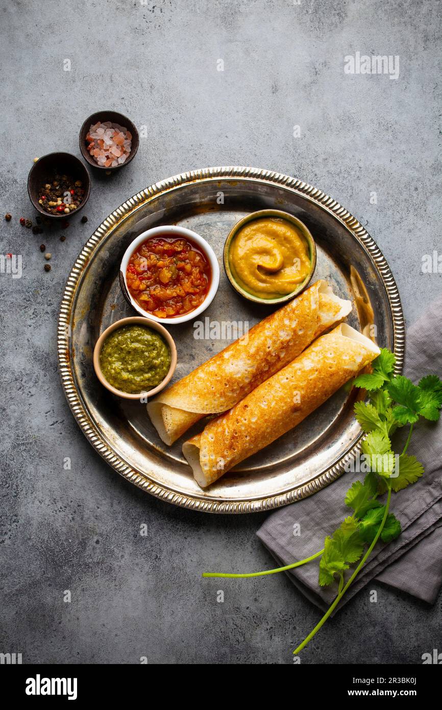 Traditional Indian rice pancakes Dosa with different dips chutney and seasonings Stock Photo Alamy
