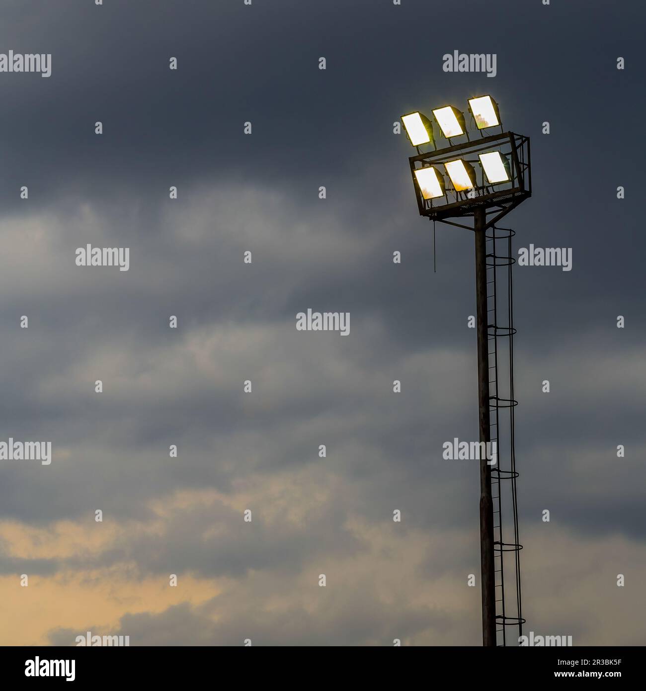 Bright sports stadium lights on a cloudy evening Stock Photo Alamy
