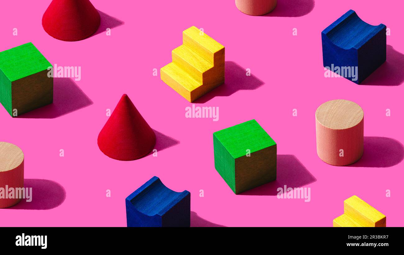 3D pattern of colorful toy blocks flat laid against pink background ...