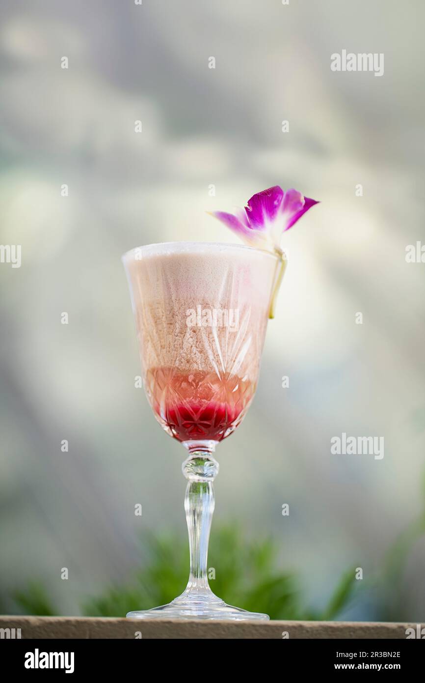 A creamy cocktail with brandy, red Port wine, coconut syrup and