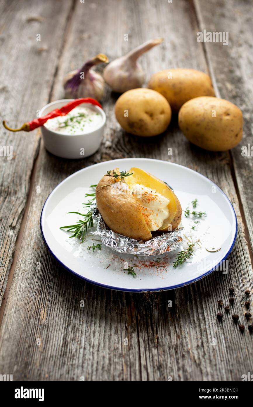 Jacket potato with yoghurtherb dip Stock Photo Alamy