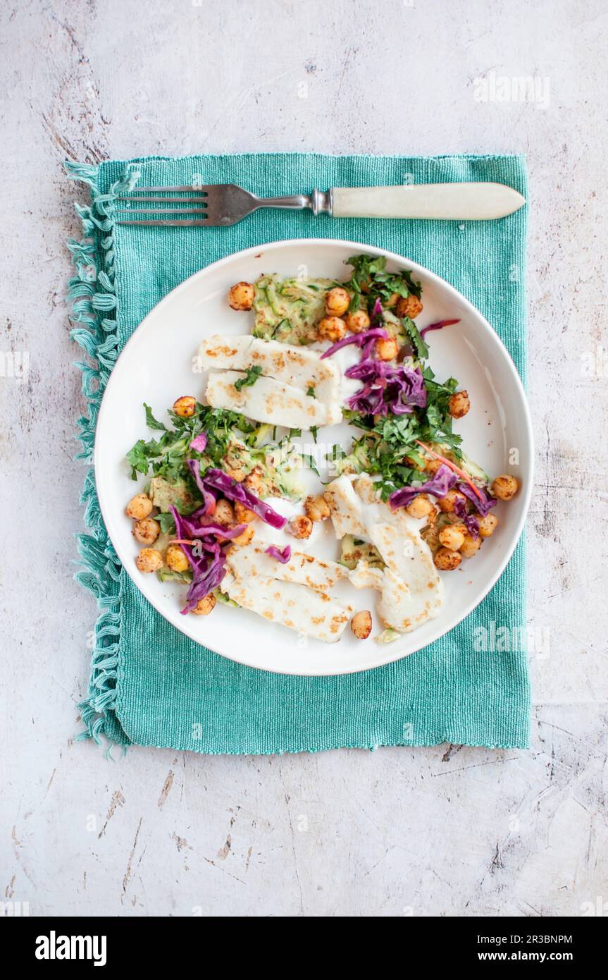 Courgette cakes with spicy chickpeas, red cabbage, herbs and fried