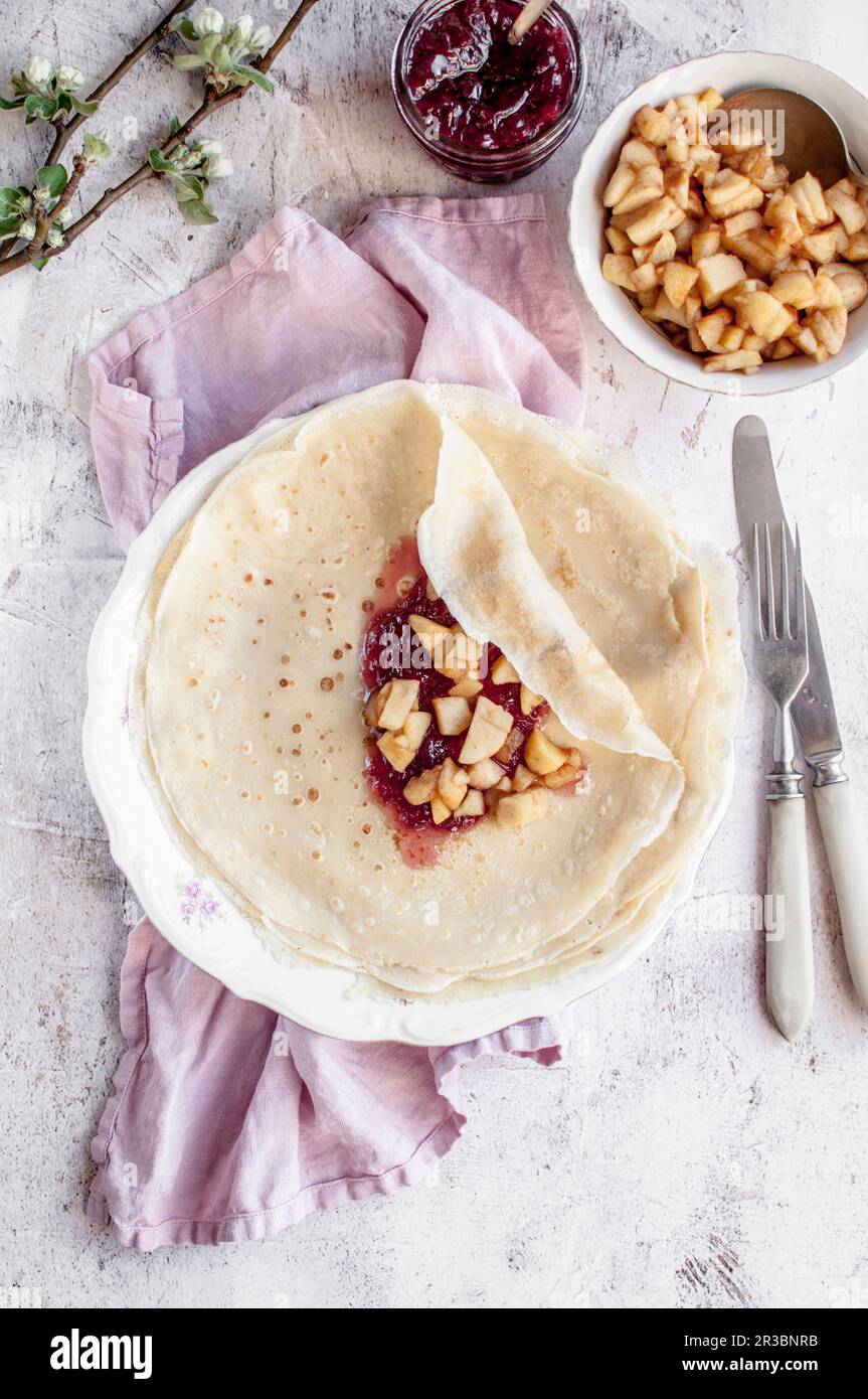 Crepes with rose petal jam and pan fried apples Stock Photo