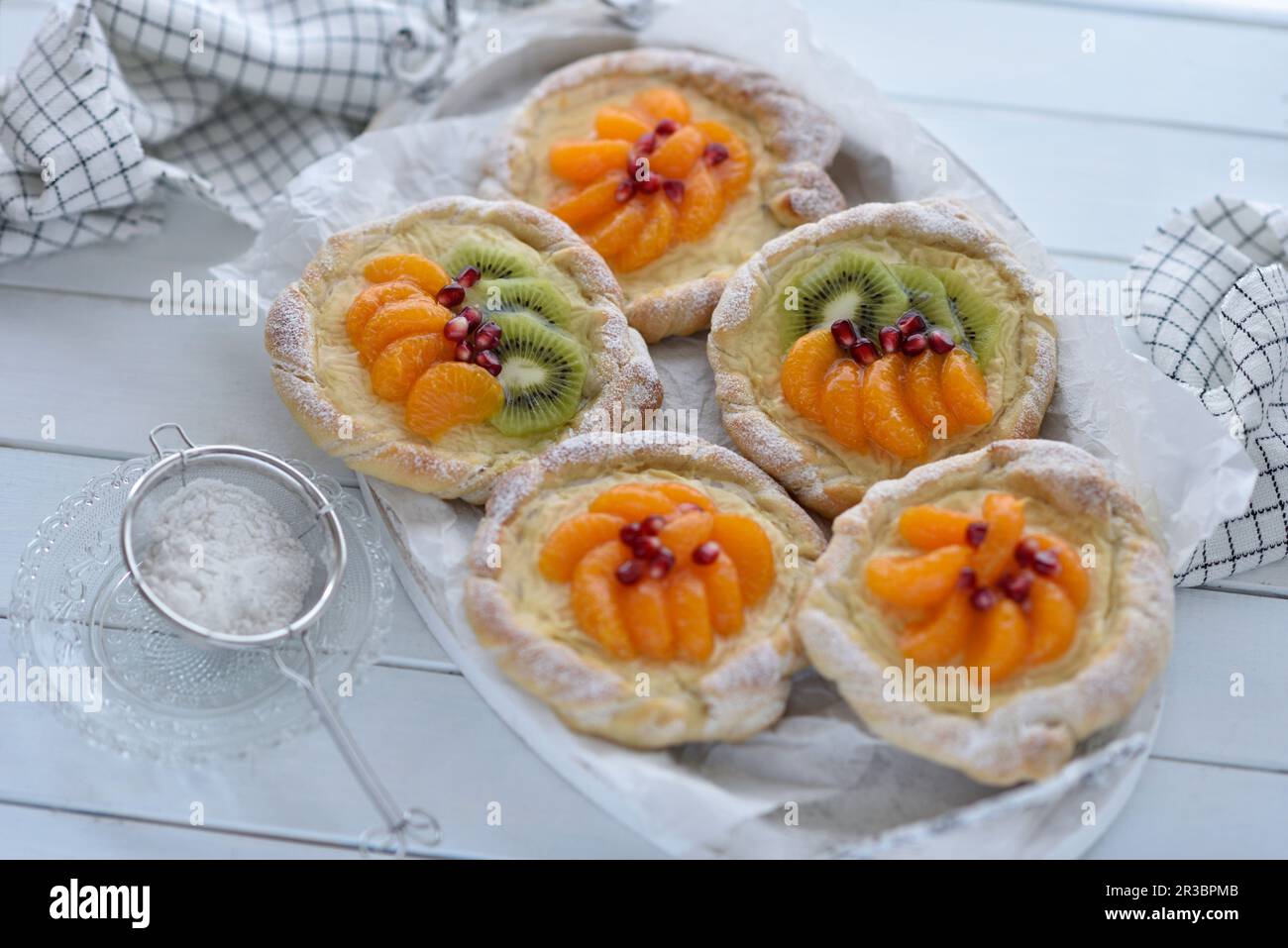 Vegan Danish pastry with kiwis, vanilla curd, and mandarins Stock Photo