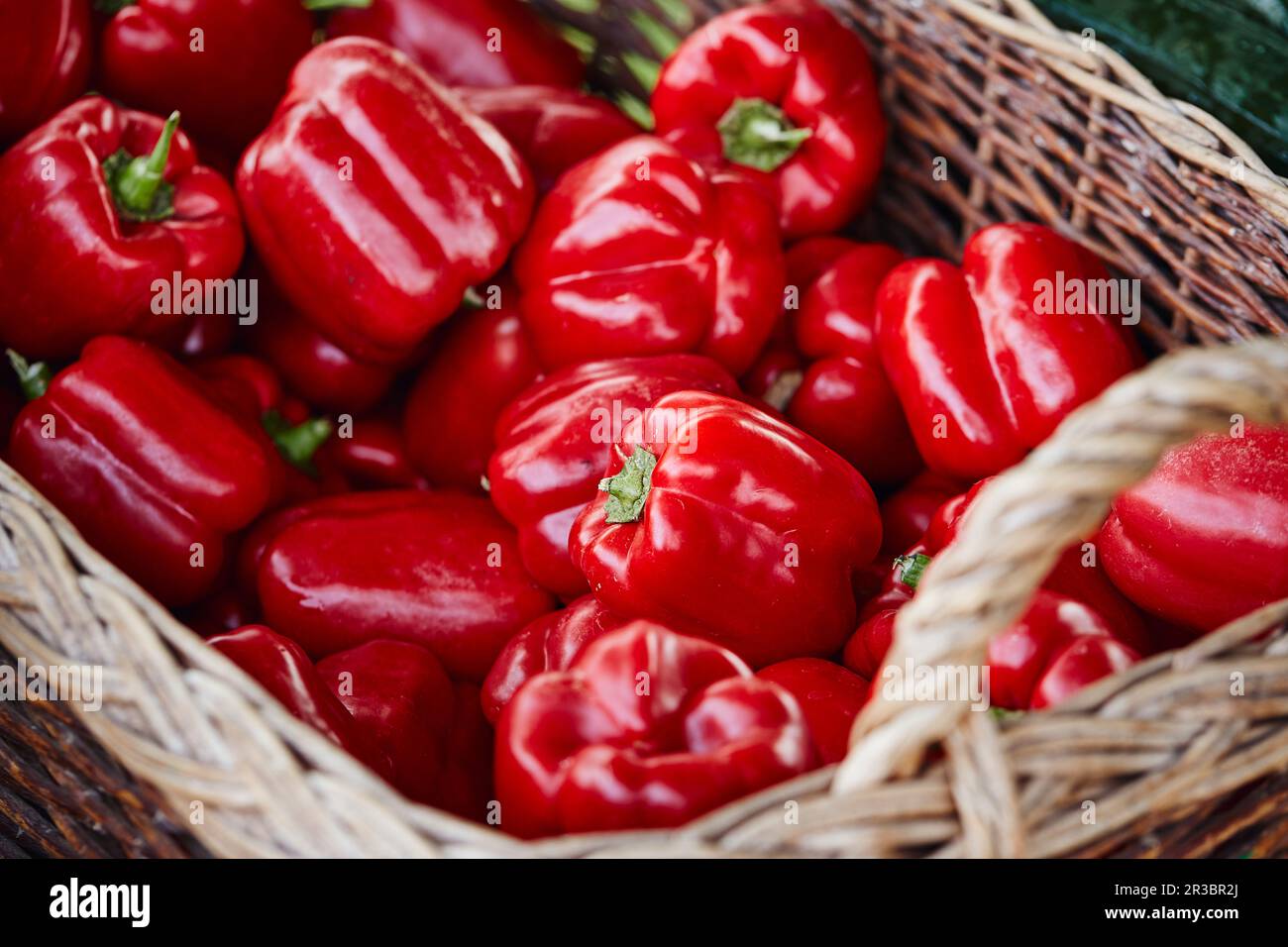 Red peppers in a basket on a market stall Stock Photo - Alamy