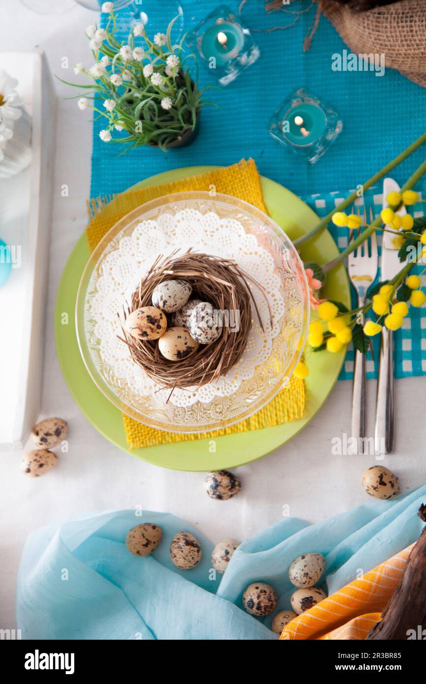 Easter table setting with quail eggs Stock Photo