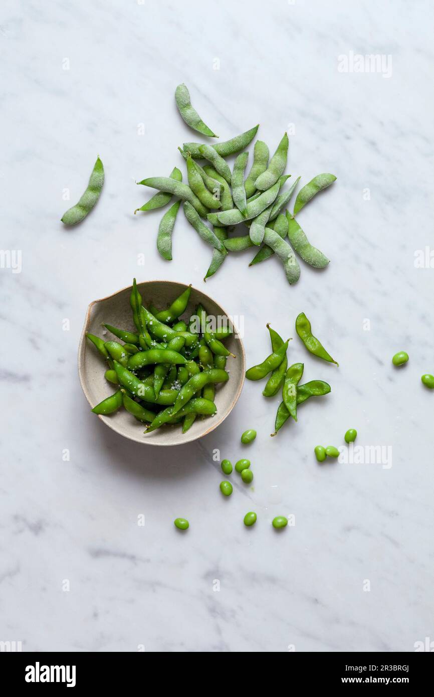 Edamame, raw and cooked Stock Photo Alamy