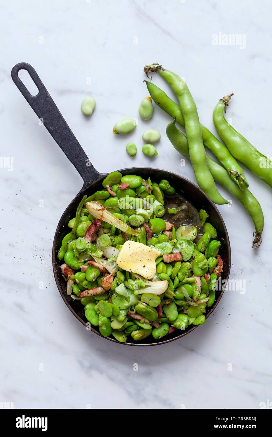 Fried broad beans with bacon in a pan Stock Photo Alamy