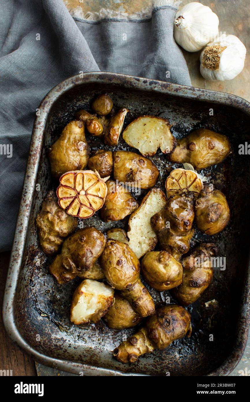 Ovenroasted Jerusalem artichokes with garlic Stock Photo Alamy