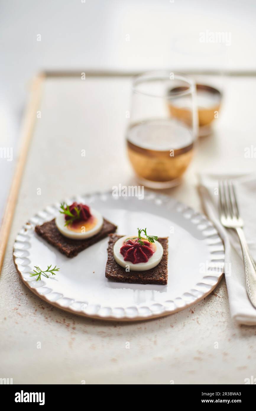 Pumpernickel with boiled egg and beetroot cream Stock Photo